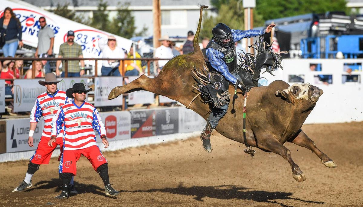 Brady Oleson rides Lap Dance in the first section of bull riding during the Professional Bull Riders event on the opening day of the Clovis Rodeo on Wednesday, April 20, 2022.