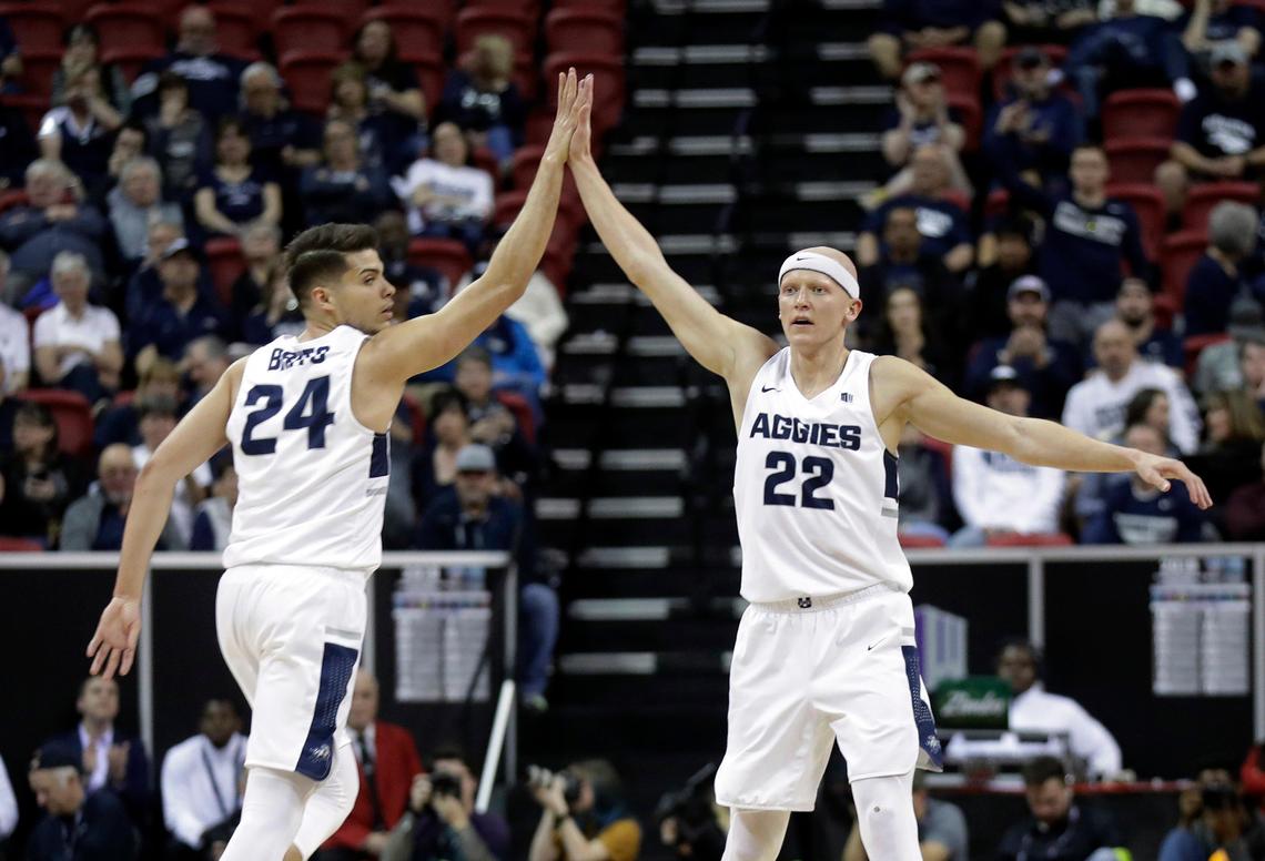 Utah State’s Diogo Brito (24) congratulates Brock Miller (22) after a score during the first half of the team’s NCAA college basketball game against Fresno State in the Mountain West Conference Tournament Friday, March 15, 2019, in Las Vegas.