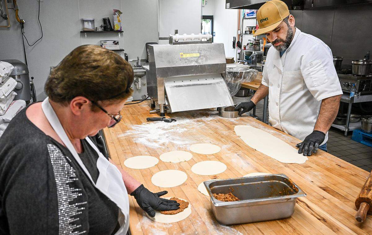 Chef Anas Hamad and Nargiz Pogosyan prepare lahmajoun, or Armenian pizza, at Rumi Baklava, a new bakery on West Shaw Avenue at Marks in Fresno.