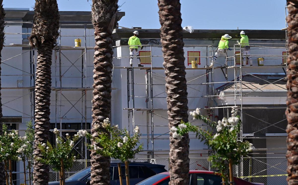 Construction workers continue work on a new large structure, expanding the Loma Vista Marketplace shopping center on the southwest corner of Shaw and Leonard avenues, seen Thursday, July 10, 2025 in Clovis.