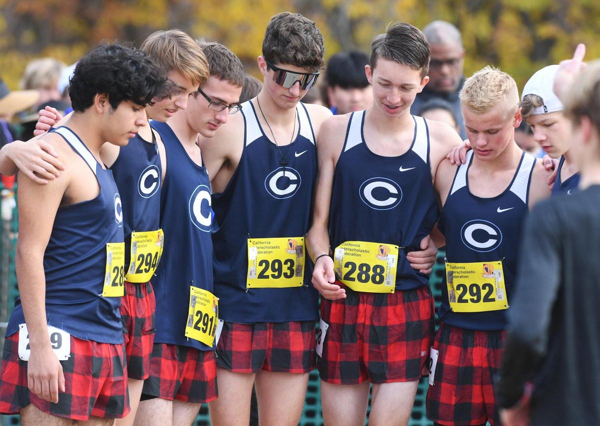 The Central Valley Christian team gathers at the starting line for the CIF State Boys D-V Cross Country Championship Saturday, Nov. 26, 2022 in Fresno.