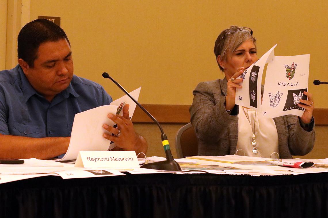 Committee members Raymond Macareno and Carrie Groover look at the finalist entries No. 7, 34, 35, 56 and 59 during Wednesday, July 10 meeting at the Visalia Convention Center.