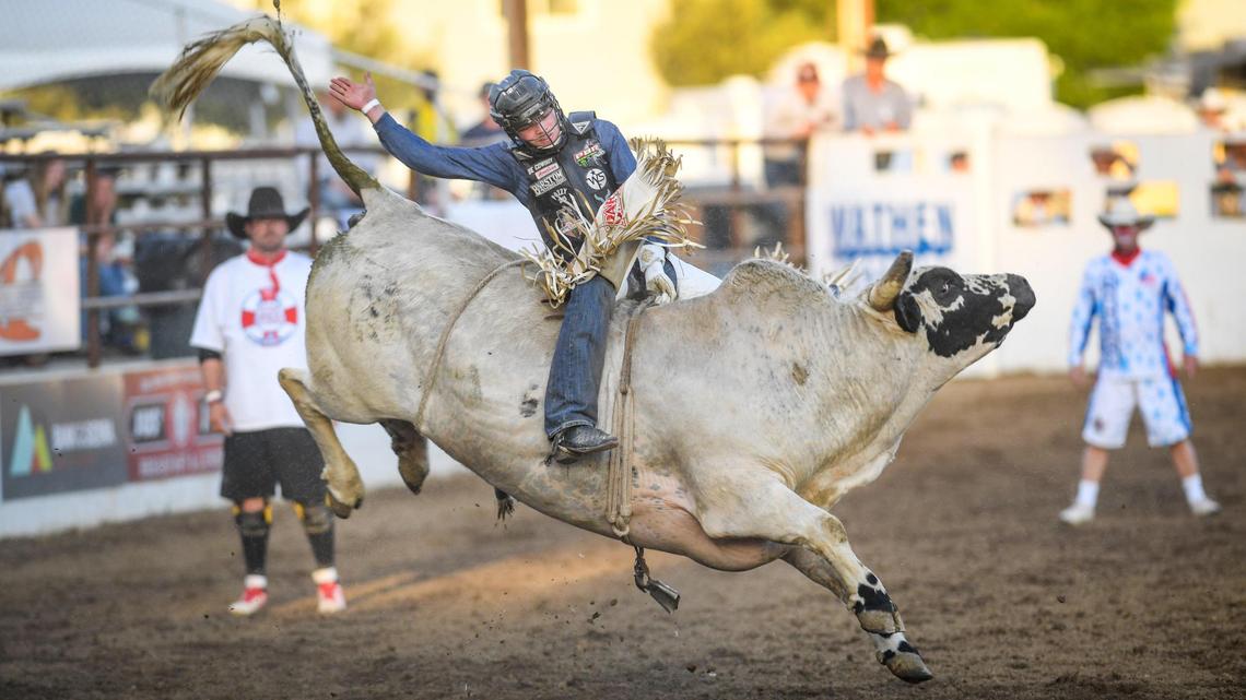 Pro bull rider Boudreaux Campbell rides his bull Red Beard during the PBR event on the first night of the Clovis Rodeo at the Clovis Rodeo Grounds on Wednesday, April 21, 2021.