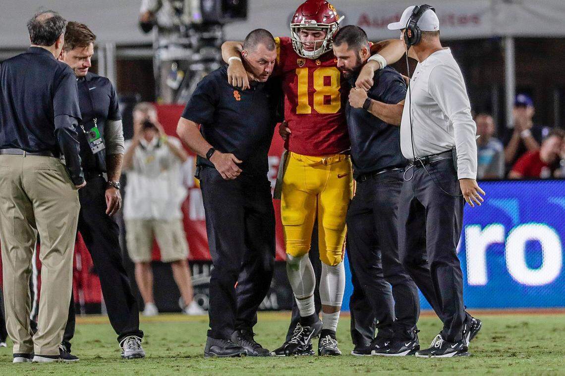 USC quarterback J.T. Daniels (18) is helped from the field against Fresno State in the second quarter at the Los Angeles Coliseum on Saturday, Aug. 31, 2019. (Robert Gauthier/Los Angeles Times/TNS)