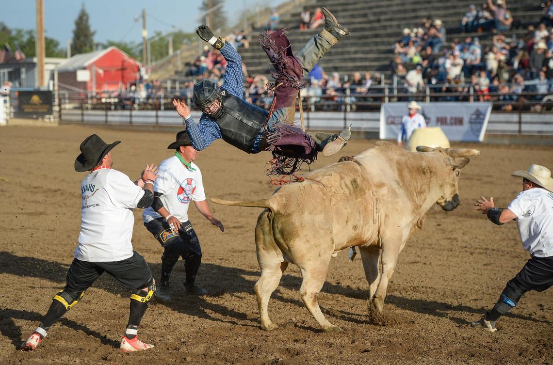 Pro bull rider Maverick Potter flies off of his bull Two Chains but only after scoring 84.50 during the PBR event on the first night of the Clovis Rodeo at the Clovis Rodeo Grounds on Wednesday, April 21, 2021.