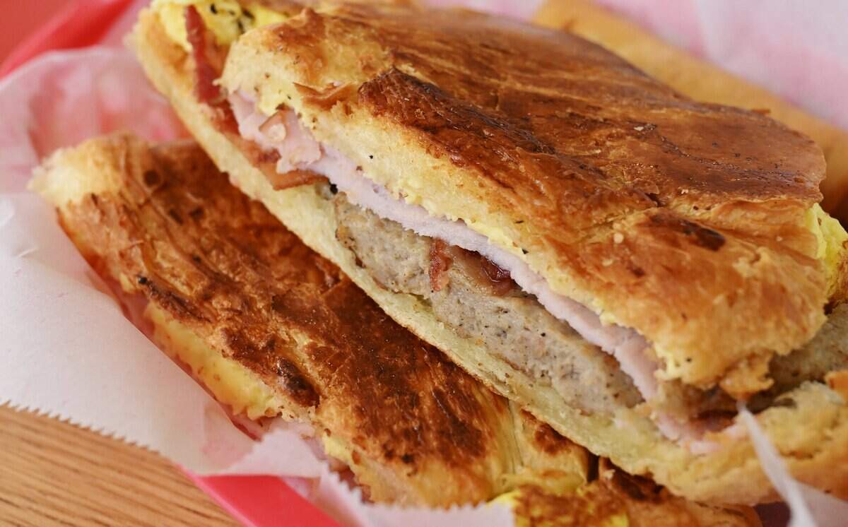 A Breakfast Sausage, Egg and Ham croissant is seen at City Donuts in the former Supreme Donuts location at the corner of Palm and McKinley avenues Wednesday, Oct. 22, 2025 in Fresno.
