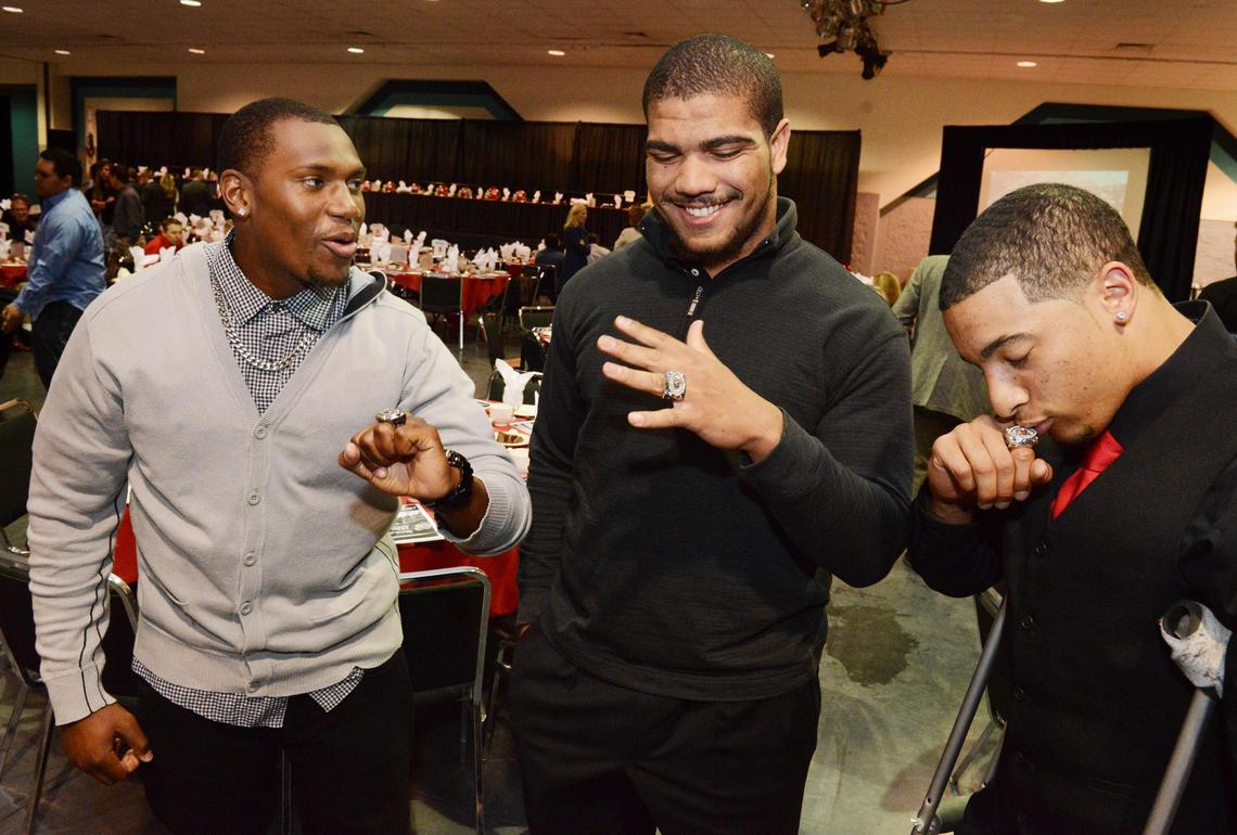 Fresno State football players, from left, Greg Watson, Donovan Lewis and Derron Smith display their excitement after receiving their Mountain West division championship rings along with the rest of the team at their annual awards banquet in Fresno Friday, March 22, 2013.