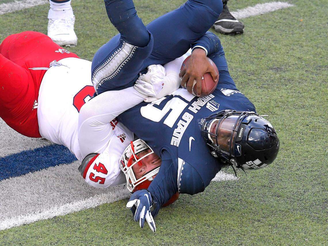 Fresno State defensive lineman Kurtis Brown (45) sacks Utah State quarterback Jason Shelley (15) during the first half of an NCAA college football game, Saturday, Nov. 14, 2020, in Logan, Utah. (Eli Lucero/Herald Journal via AP)