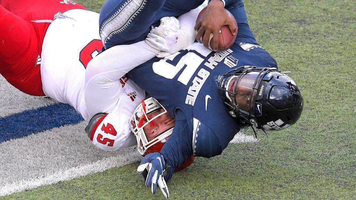 Fresno State defensive lineman Kurtis Brown (45) sacks Utah State quarterback Jason Shelley (15) during the first half of an NCAA college football game, Saturday, Nov. 14, 2020, in Logan, Utah. (Eli Lucero/Herald Journal via AP)