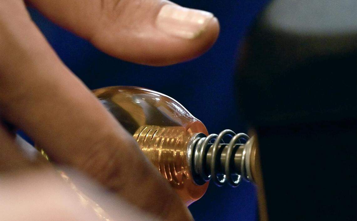 A player reaches for the launcher at Fresno Flip or Fail Pinball Club's pinball pop-up held at Summer Fox Saturday, Dec. 6, 2025 in Clovis.