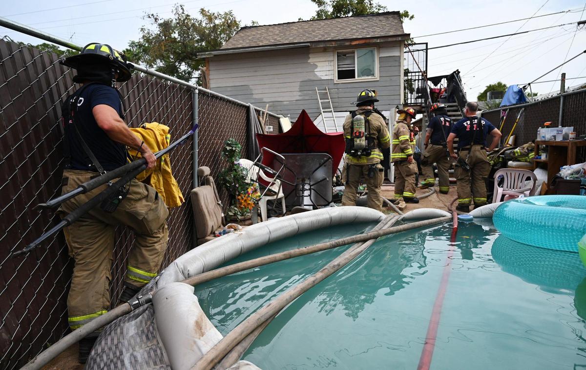 A pool partially slowed access to an apartment fire, background, according to Fresno Fire Battalion Chief Tony Escobedo after crews responded to report of the fire Thursday, Aug. 4, 2022 in Fresno. Nobody was seriously injured though Escobedo said one woman was treated and taken to a hospital for smoke inhalation.