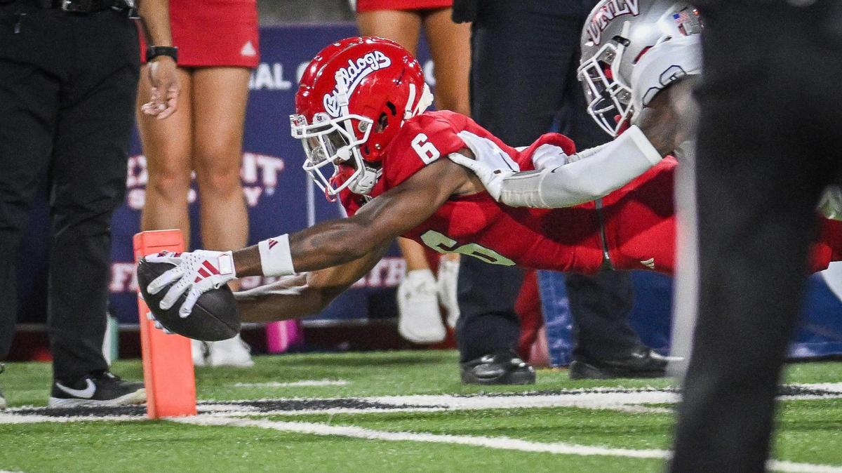 Fresno State’s Tim Grear Jr. stretches for the goal line for a touchdown after taking a long pass from quarterback Mikey Keene while defended by UNLV’s Quentin Moten in the first quarter of their game at Bulldog Stadium on Saturday, Oct. 28, 2023.