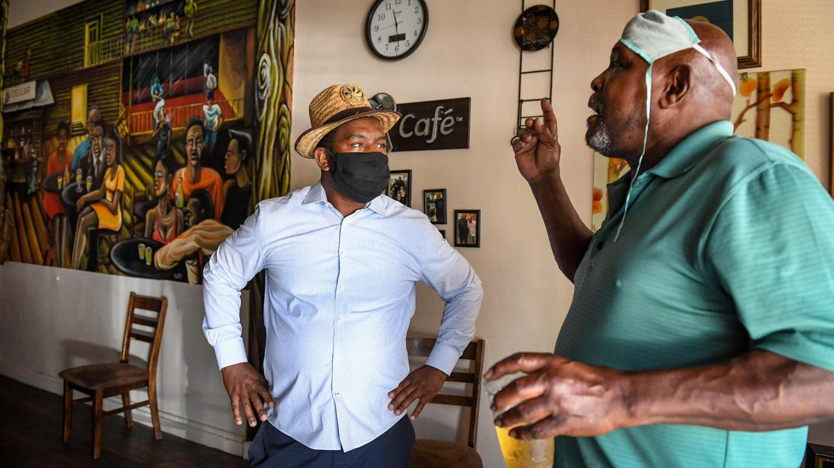 Tate Hill, left, speaks with chef Paul Pearson at Pearson’s restaurant Chef Paul’s Cafe in Fresno’s Chinatown on Wednesday, July 1, 2020. The restaurant won the Fresno Bee’s poll of Black-owned places to eat and drink in Fresno and Clovis.