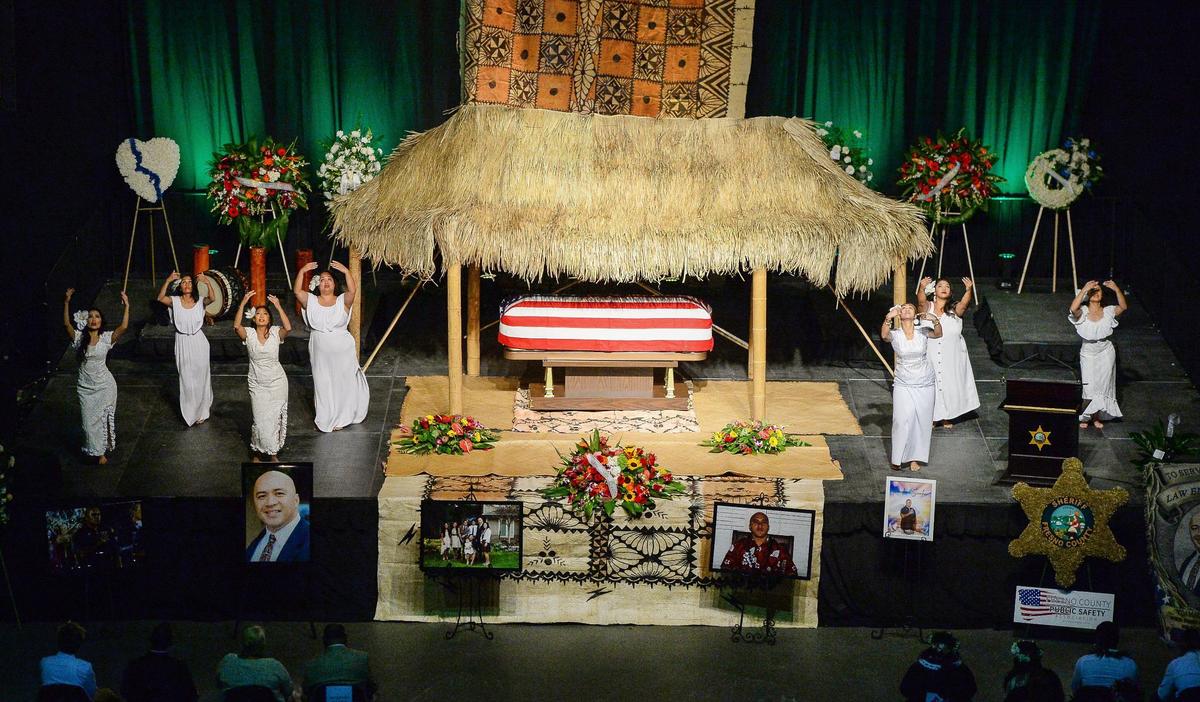 Members of the Polynesian Club of Fresno perform a prayer hula during a memorial service held for Fresno County Sheriff’s Office correctional officer Toamalama Scanlan at the Save Mart Center in Fresno on Monday, Oct. 25, 2021.