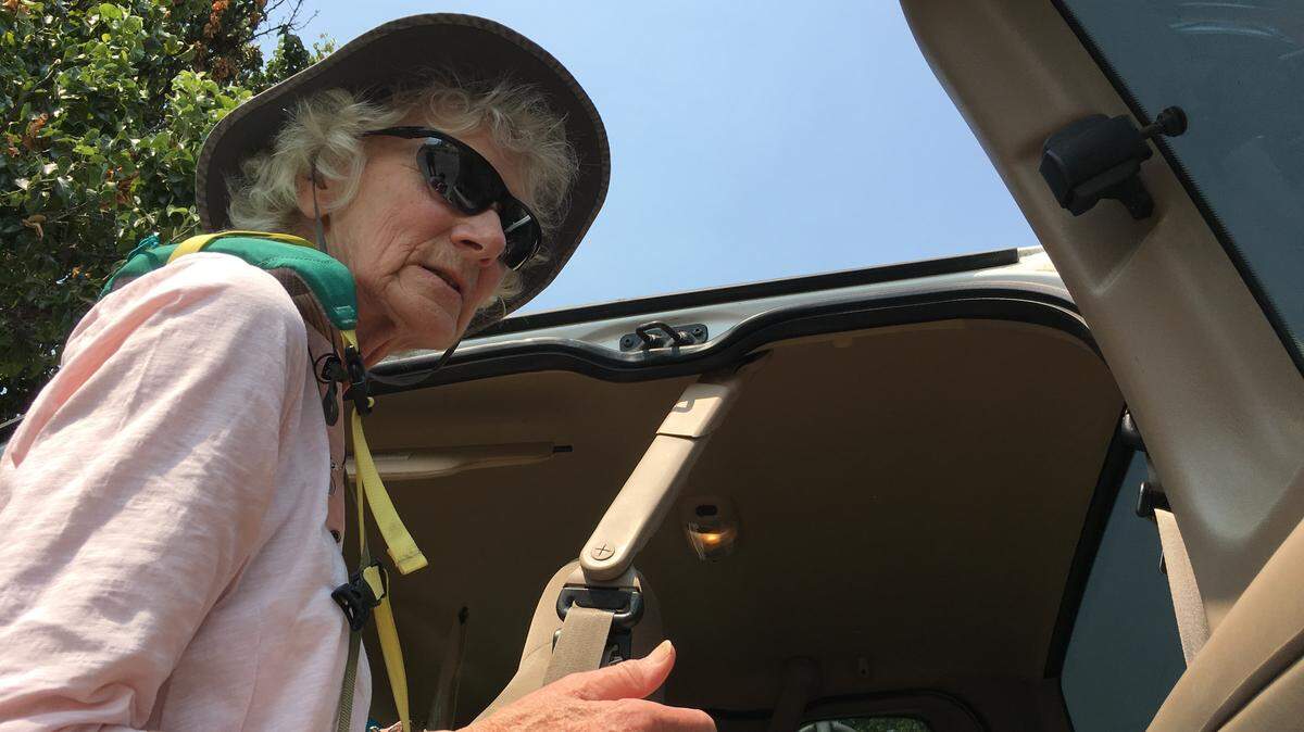 Juanita Smith, 77, searches inside her Ford F-150 where she keeps her belongings after she evacuated her home near Mariposa, CA due to the Ferguson Fire. Smith is staying in the Red Cross shelter at Mariposa Elementary School.