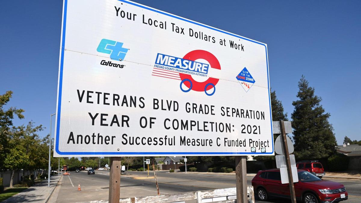 A sign near the Veterans Boulevard project near Golden State Boulevard and Highway 99 in northwest Fresno prominently touts the success of Measure C, the half-cent sales tax to support road and transportation improvements in Fresno County that expires in 2027.
