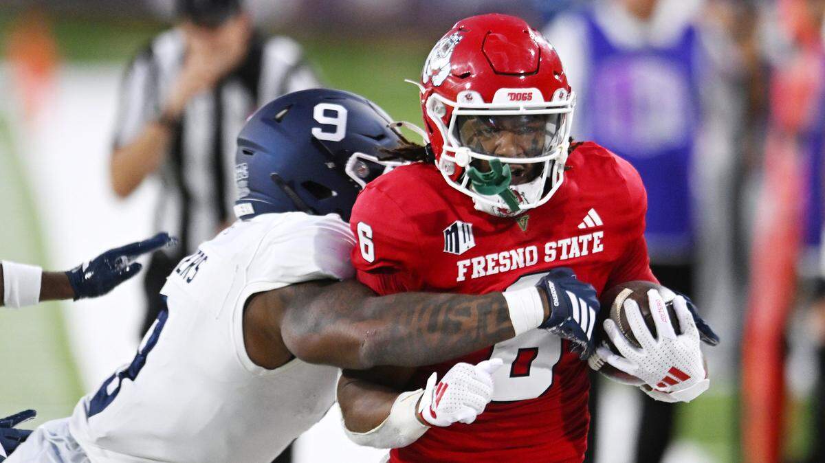 Fresno State's Bryson Donelson is forced out of bounds by Georgia Southern's Justin Meyers, left, Saturday, Aug. 30, 2025 in Fresno.