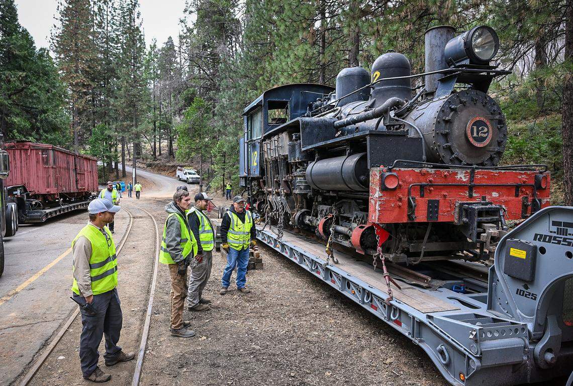 Yosemite Mountain Sugar Pine Railroad staff members look over the Shay #12 locomotive as it arrives at the Railroad in Fish Camp from its former home in Colorado on Monday, February. 9, 2026. It joins the railroad's two other engines, #10 and #15.