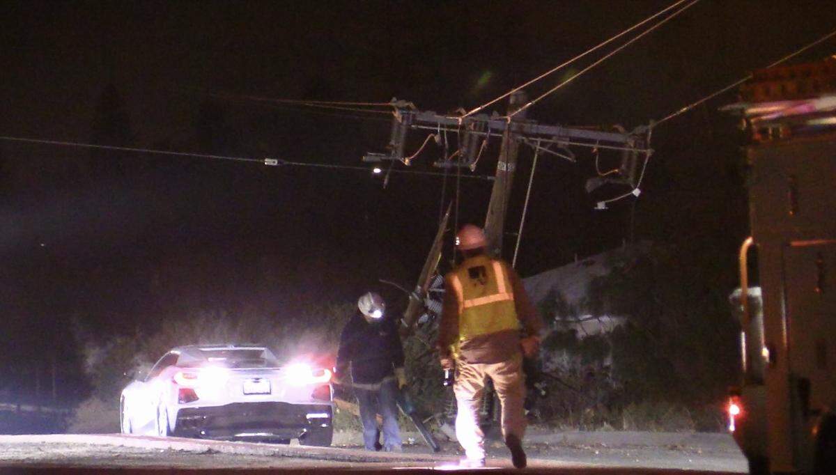 A telephone pole, including power lines came down after a vehicle (not pictured) struck it in Fresno, California on Friday, Dec. 9, 2022.