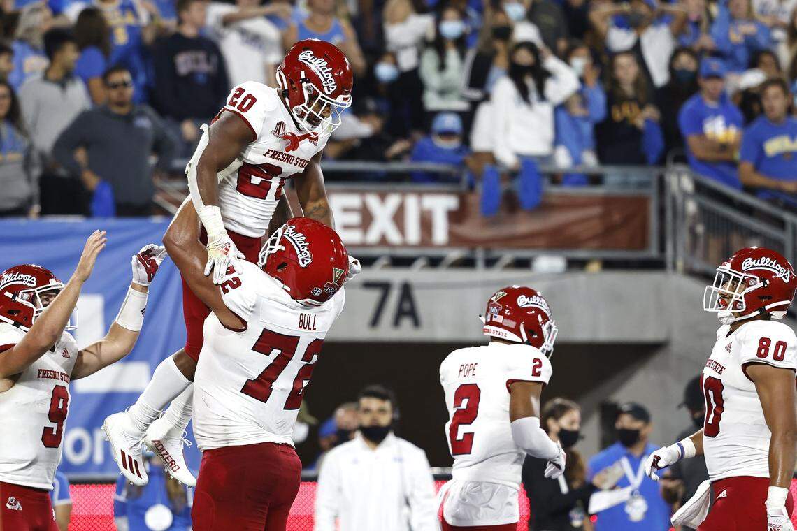 PASADENA, CALIFORNIA - SEPTEMBER 18: Ronnie Rivers #20 of the Fresno State Bulldogs celebrates with Dontae Bull #72 of the Fresno State Bulldogs after scoring a touchdown against the UCLA Bruins during the first half at Rose Bowl on September 18, 2021 in Pasadena, California. (Photo by Michael Owens/Getty Images)