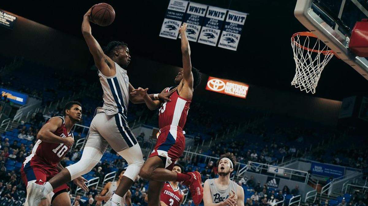 Nevada’s Warren Washington goes up for a dunk over the Fresno State defense.