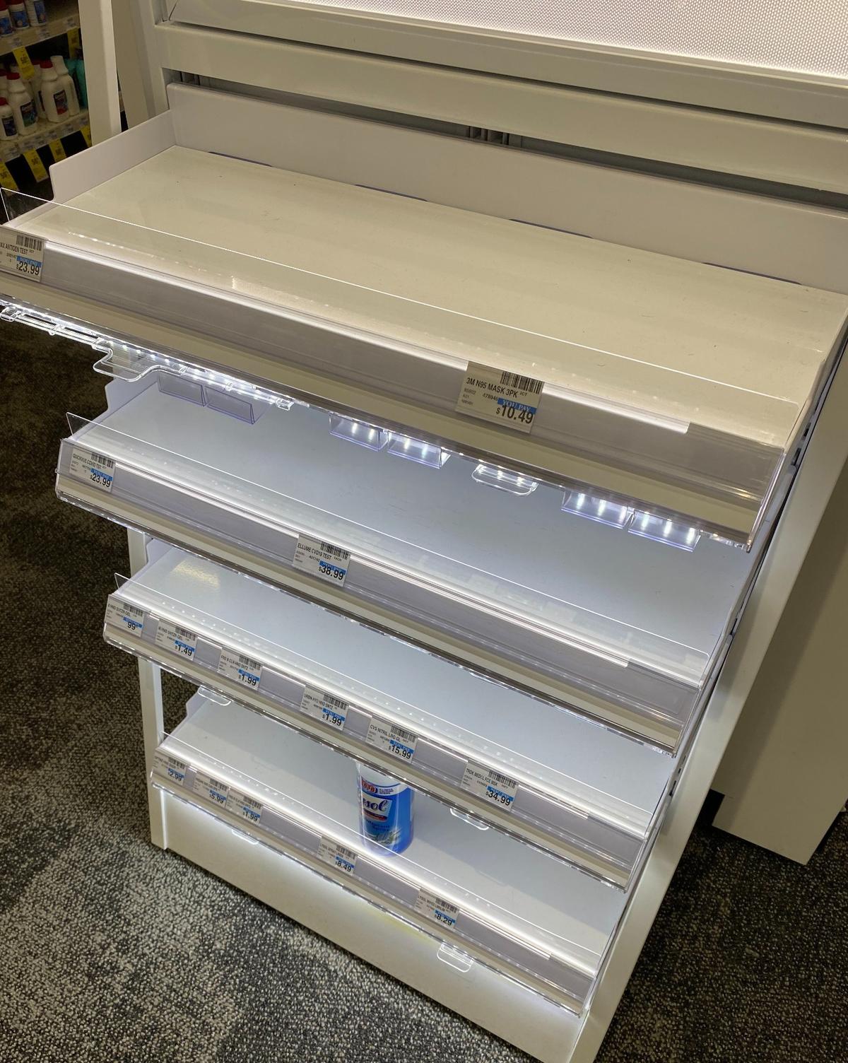 A lone can of disinfecting spray sits on a rack of shelves that would ordinarily stock several brands of at-home COVID-19 rapid-test kits at a CVS store in northwest Fresno on Monday, Dec. 27, 2021. The store had been sold out of kits for about a week, and it was not known when more would arrive.