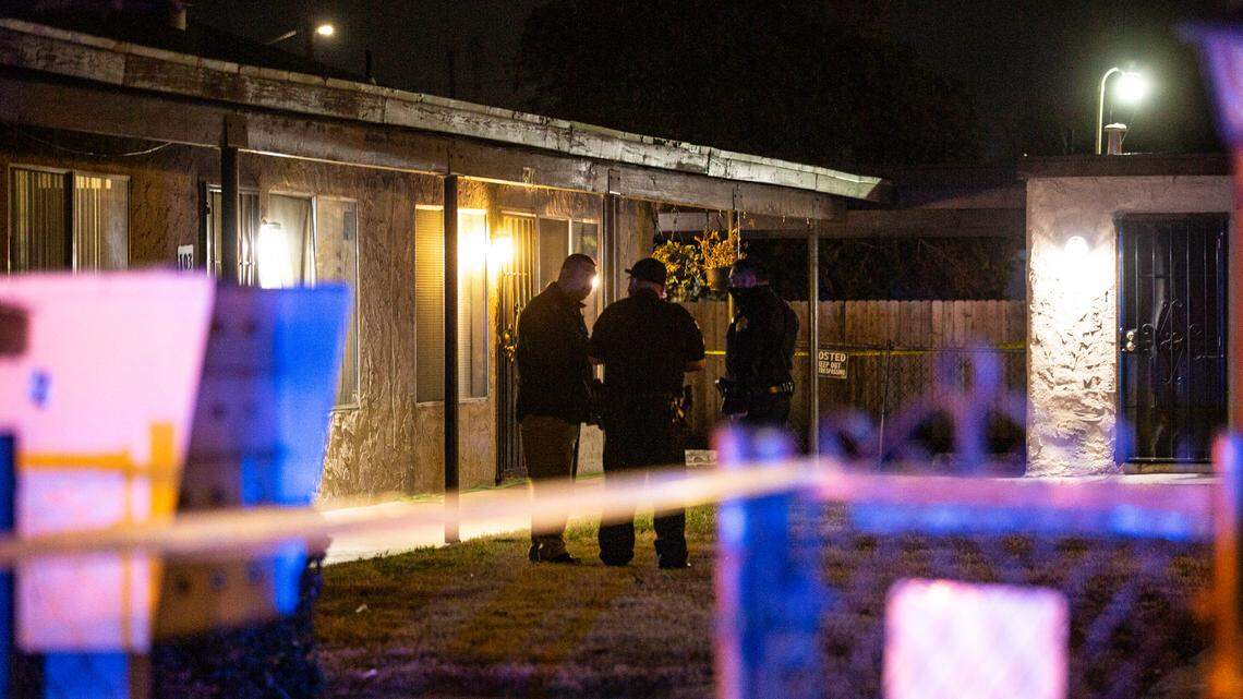 Police talk in the courtyard of a central Fresno apartment complex where officers found a shooting victim Monday, Nov. 14, 2020.
