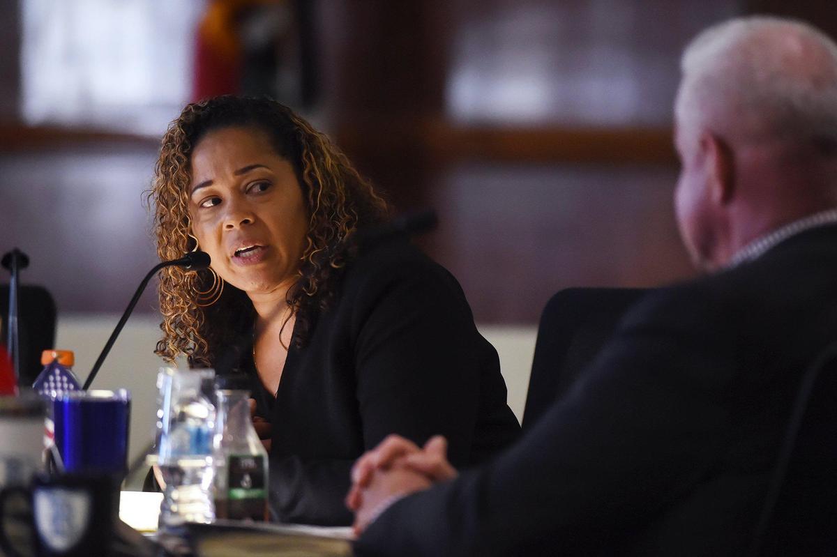 Fresno Unified School Board Trustee Keshia Thomas, left, speaks to board member Terry Slatic, right, in a 2019 meeting.