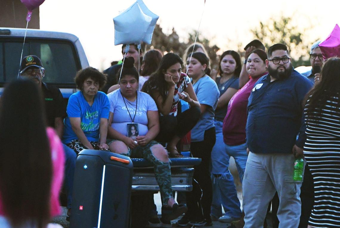 About 100 people gathered for a vigil for Yanelly Solorio Rivera, 18, and her 3-week-old girl, Celine Solorio Rivera on Tuesday evening, Sept. 27, 2022 south of Fresno. The two died after being shot at their rural home Saturday. Police are still searching for the killer.