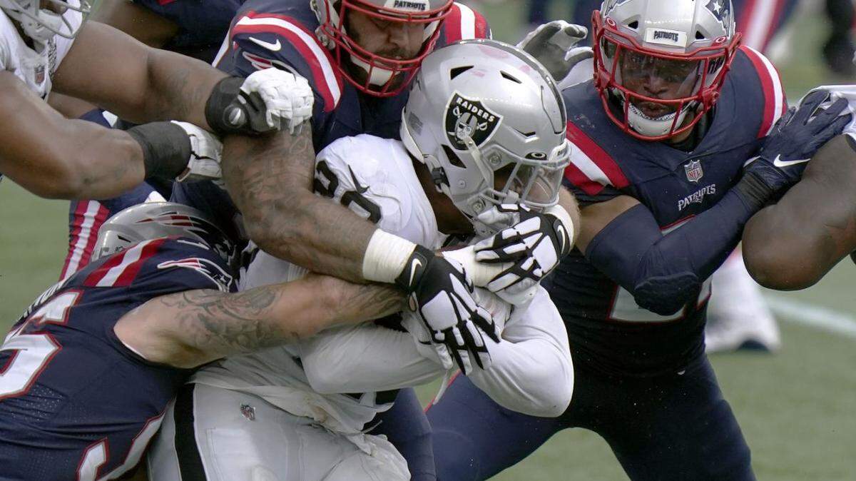 New England Patriots defenders combine to tackle Las Vegas Raiders running back Josh Jacobs (28) in the first half of an NFL football game, Sunday, Sept. 27, 2020, in Foxborough, Mass. (AP Photo/Steven Senne)