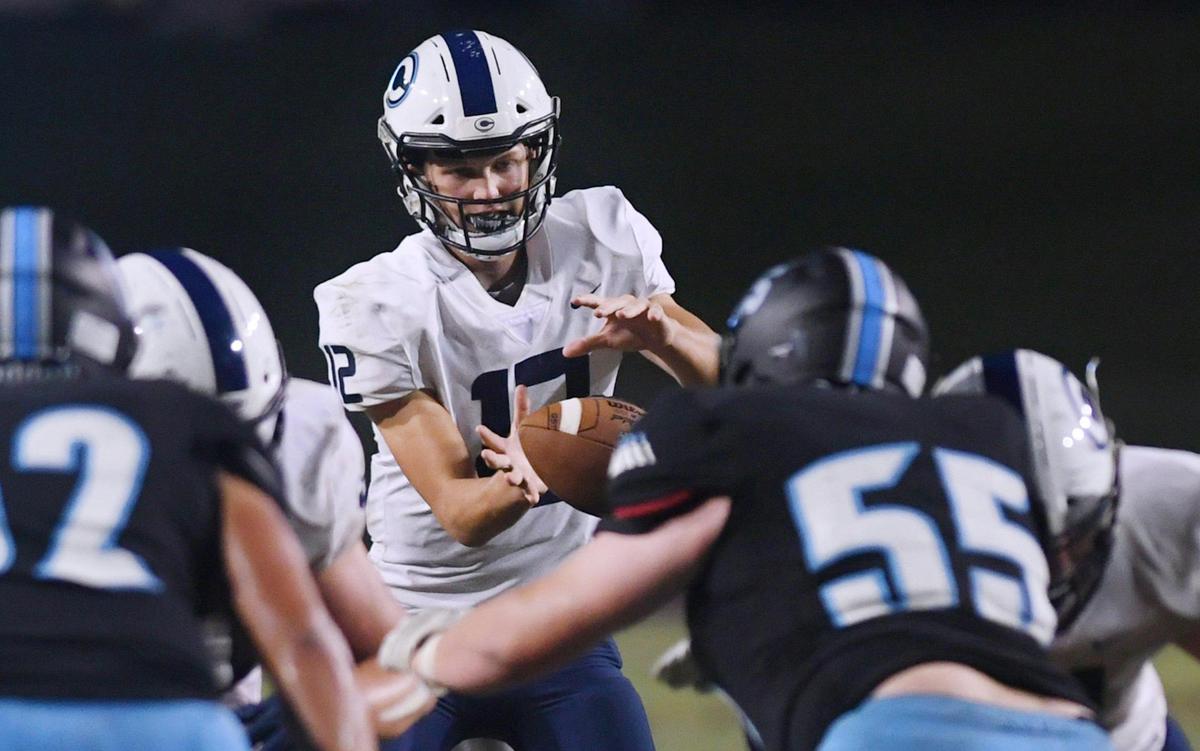 Central Valley Christian quarterback Max Bakker, center, takes the snap on a play against Clovis North in second half action Friday, Sept. 9, 2022 in Clovis. CVC won the nonleague game 23-9.