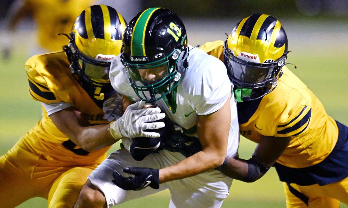 Roosevelt’s Giovanny Alvarez, center, is tackled by Sunnyside’s defense Friday, Oct. 4, 2024 in Fresno.