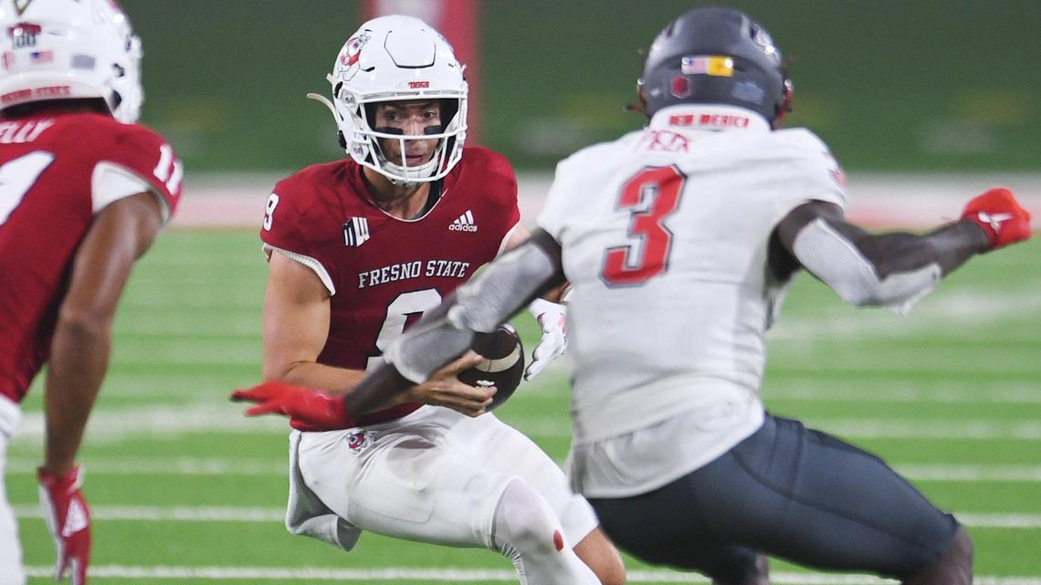 Fresno State quarterback Jake Haener scrambles for yardage while chased by New Mexico’s Patrick Peek in the Bulldogs 34-7 victory over the Lobos Saturday, Nov. 13, 2021 in Fresno. Haener hit 24 of 31 passes for 300 yards and three touchdowns in the win.