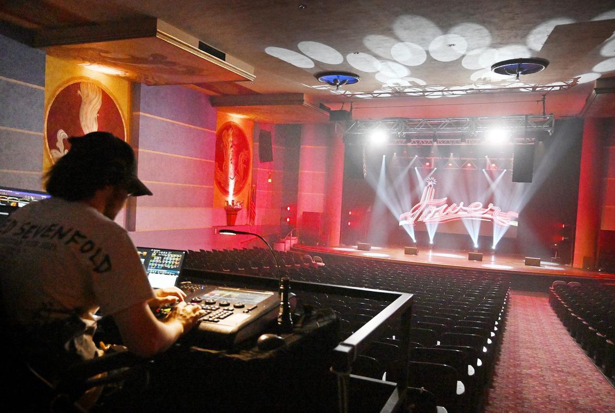 Lighting designer Noah Turner runs through lighting patterns at the Tower Theatre Thursday, July 11, 2024 in Fresno. The historic venue has been under new management for the past year, increasing services and features offered for performances.