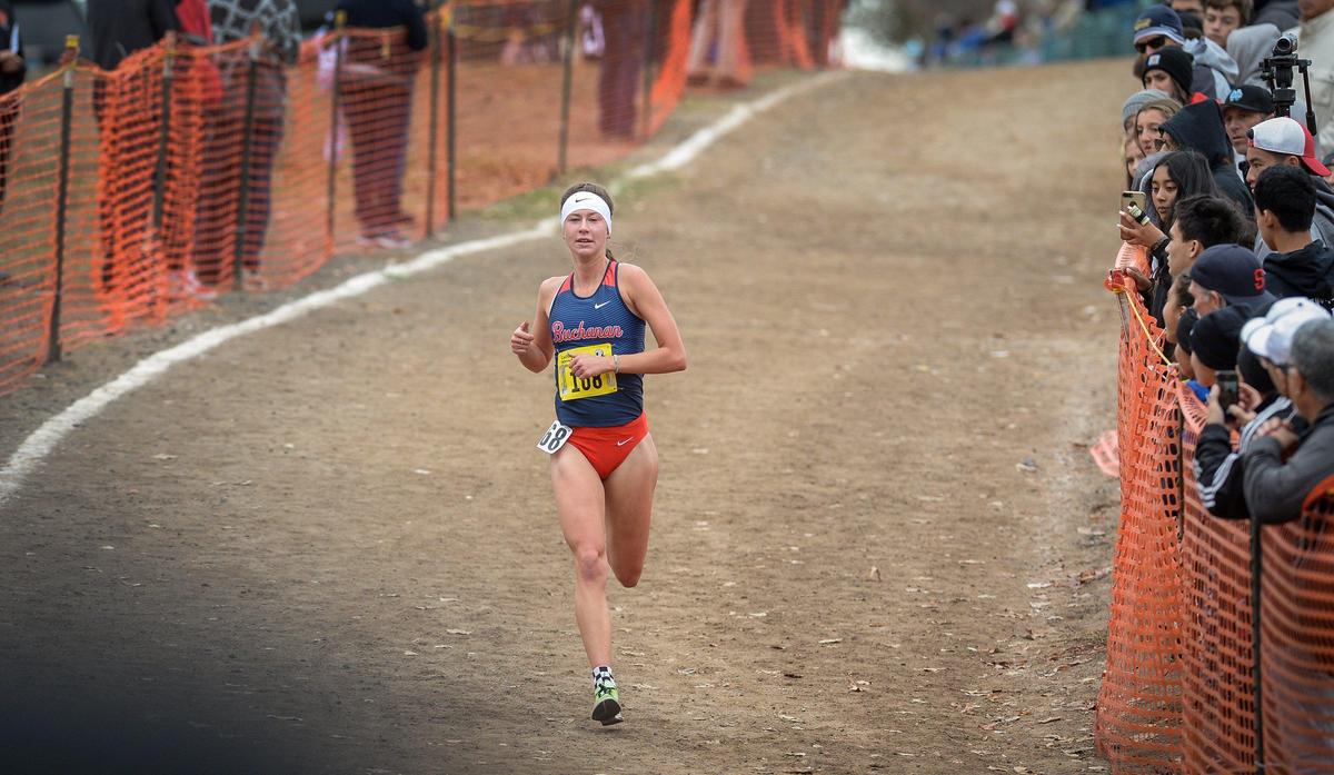 Buchanan’s Cori Smith is all alone at the three-mile mark but well behind first place finisher Carlie Dorostkar of Canyon Crest Academy in the girls D-1 California state cross country championships at Woodward Park in Fresno on Saturday, Nov. 30, 2019. Smith finished second in the state and the Buchanan team won the first place championship.