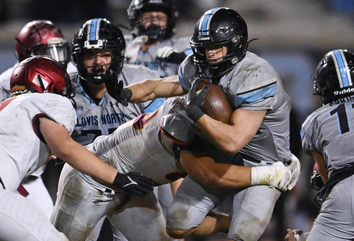 Clovis North’s Jackson Cinfel, is tackled by Clovis West’s Joseph Chacon in a Central Section Division I quarterfinal game Thursday, Nov. 9, 2023 in Clovis.