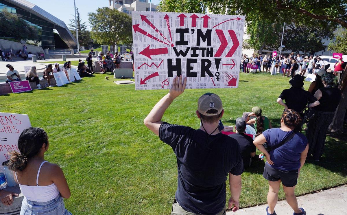 Ian Actares holds a sign in support of women’s choice as hundreds turned out to protest the Supreme Court’s overturning of Roe v. Wade Saturday morning outside City Hall, June 25, 2022, in Fresno.