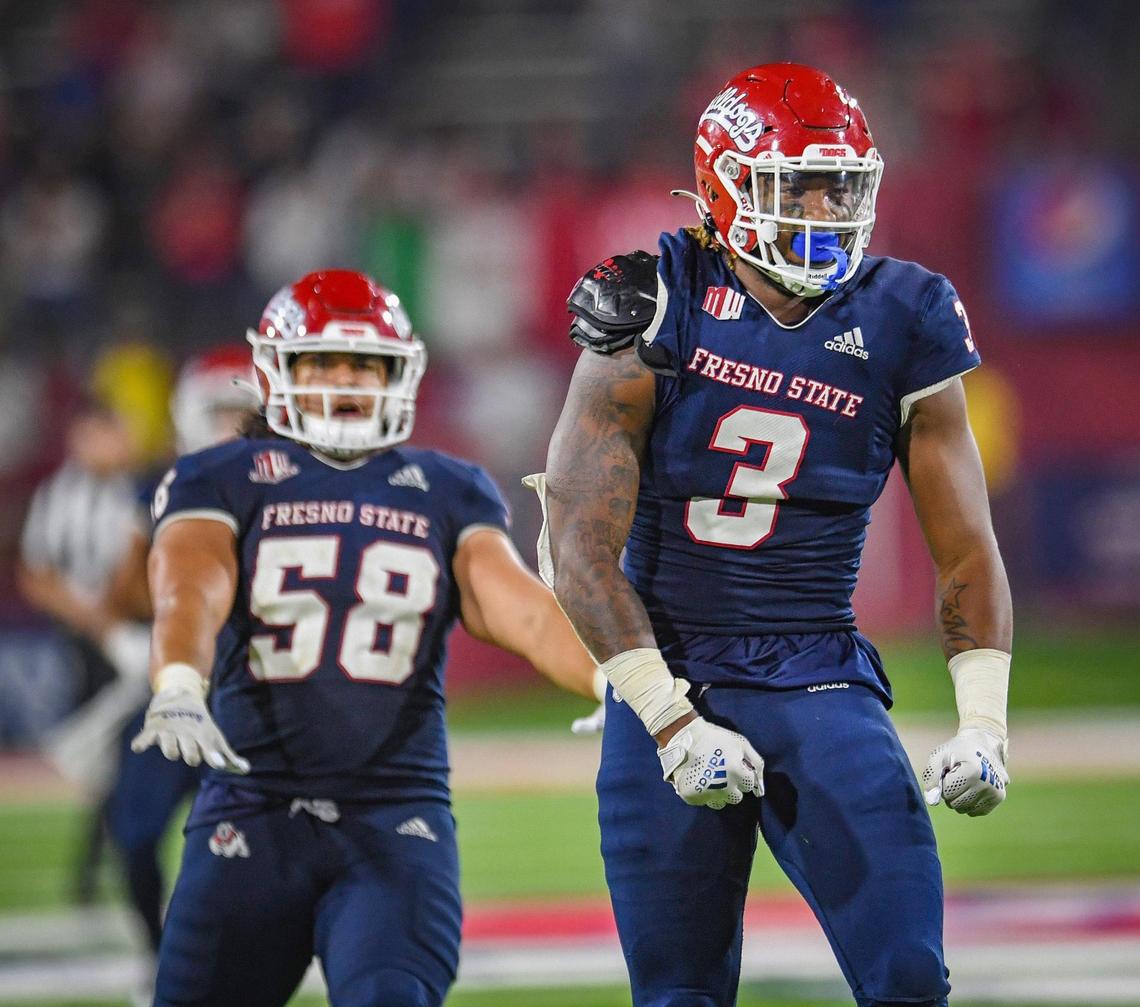 Fresno State’s Arron Mosby, right, celebrates making a play against UNLV with teammate Tyson Maeva during their game at Bulldog Stadium on Friday, Sept. 24, 2021.