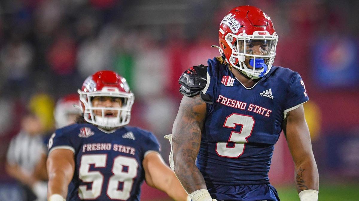 Fresno State’s Arron Mosby, right, celebrates making a play against UNLV with teammate Tyson Maeva during their game at Bulldog Stadium on Friday, Sept. 24, 2021.