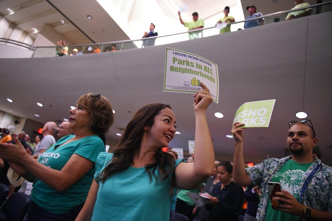 Natasha Biasell, center, looks over her shoulder after Eric Payne asked for a show of support for parks among those gathered as the Fresno City Council met to discuss and vote on the agenda’s parks tax Thursday, Aug. 9, 2018 in Fresno.