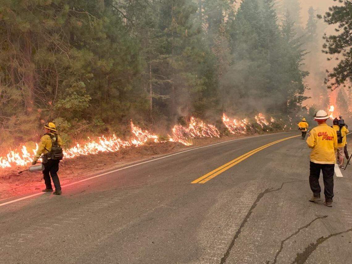 A backfire burns along Highway 168 near Lakeview Drive as firefighters attempt to burn away dry brush and starve the Creek Fire of fuel Sunday, Sept. 6, 2020.