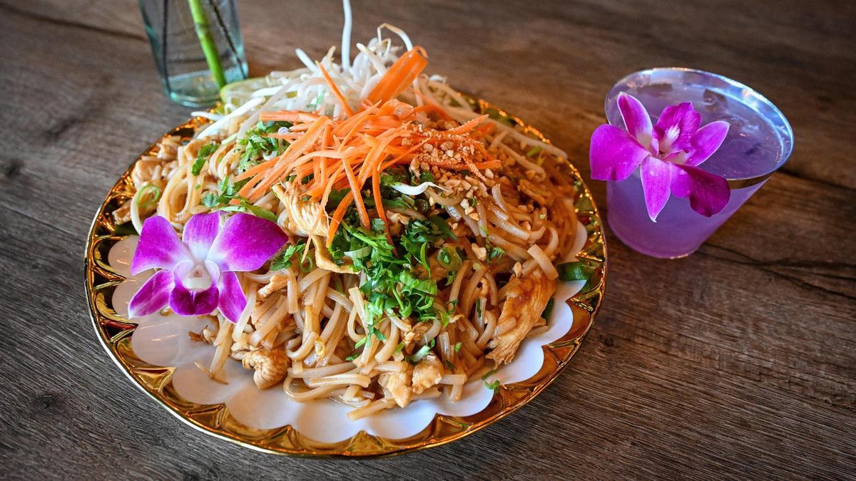 Chicken pad thai a top menu item and a lychee blossom mocktail are presented at Satay Thai Kitchen and Bar in north Fresno on Thursday, May 8, 2025.