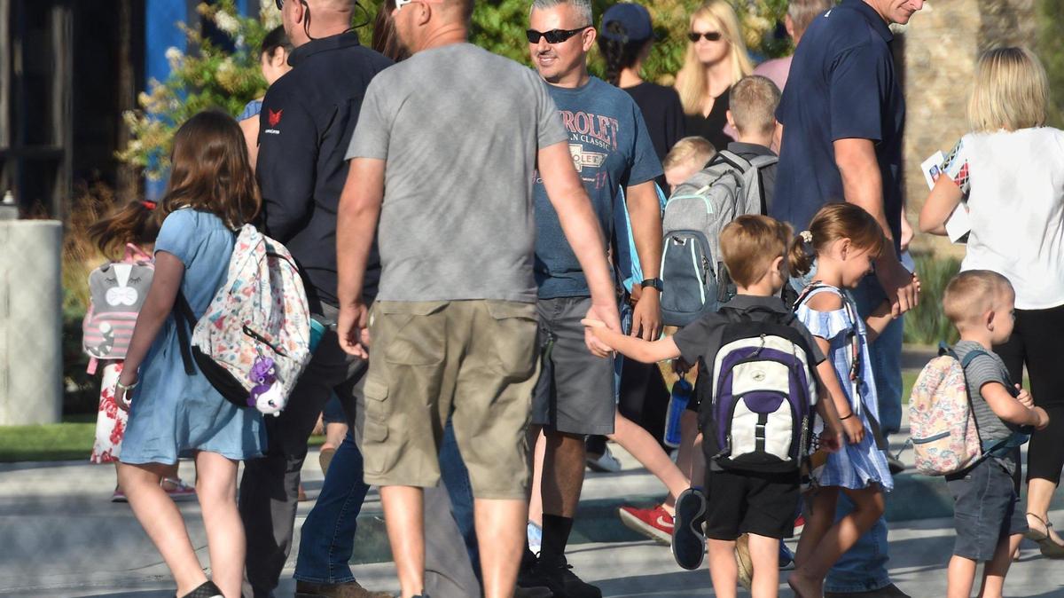 Parents bring their children back to s classes Thursday morning, Aug. 13, 2020, at Immanuel Elementary School in Reedley.