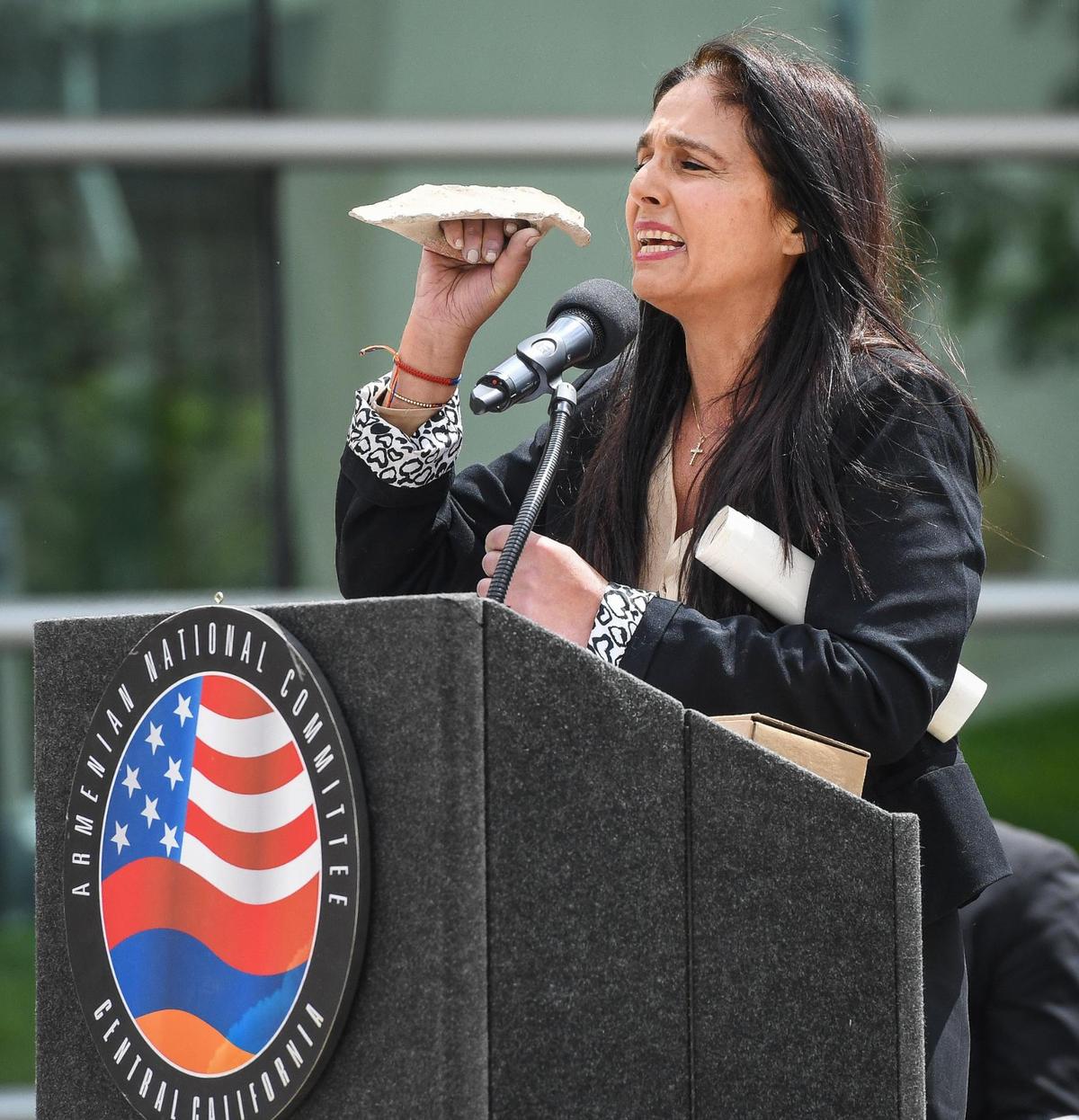 Documentary filmmaker Ani Hovannisian holds up a broken jug handle she found in Armenia while making her film The Hidden Map, during her keynote address at the annual Armenian genocide commemoration and flag raising ceremony at Fresno City Hall on Friday, April 22, 2022.