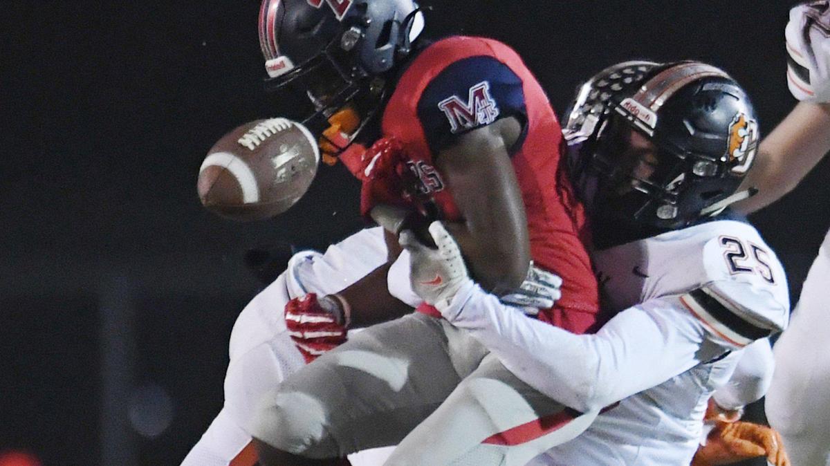 Central’s Marcus Ramirez, right, tackles San Joaquin Memorial’s Donovan Harris, knocking the ball free in a Central Section semifinal game on Friday, Nov. 19, 2021 in Fresno. Central won 37-20.