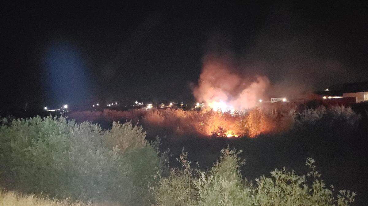 Madera County firefighters battled a fire in the Fresno riverbed Tuesday night.