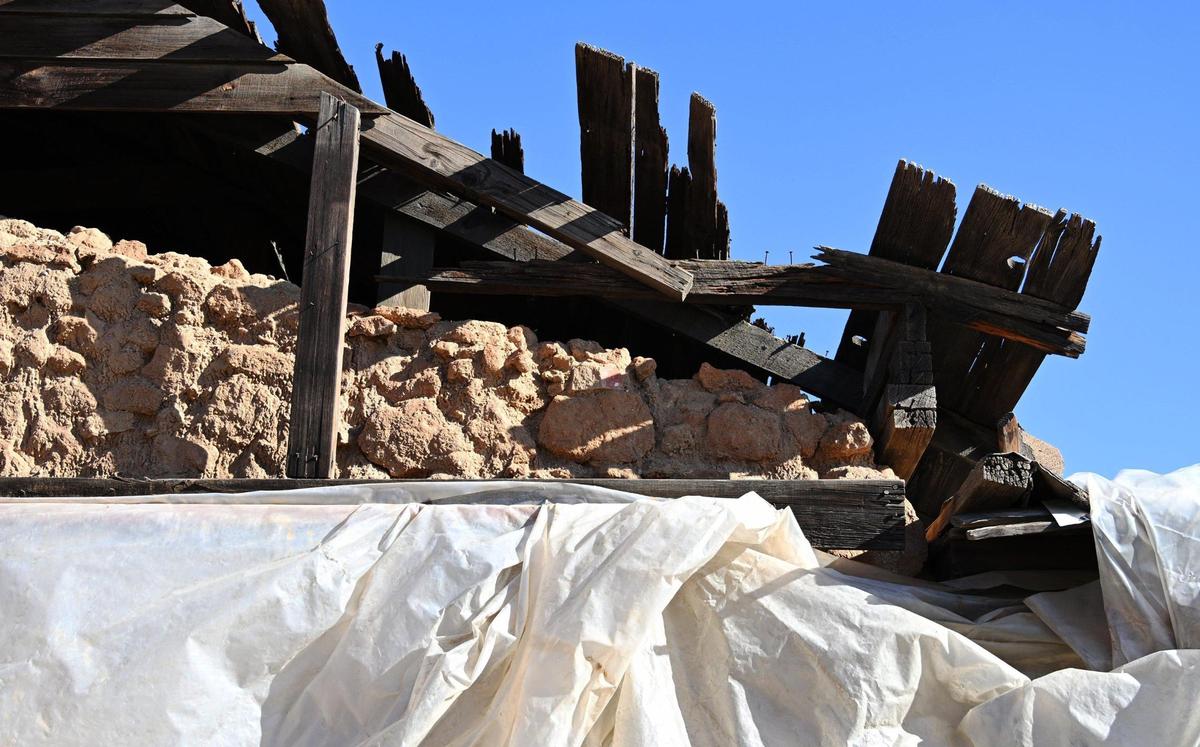 Original adobe bricks can be seen as the historic Jose Garcia Adobe sits wrapped in tattered plastic Tuesday, Nov. 28, 2023 in Fresno.