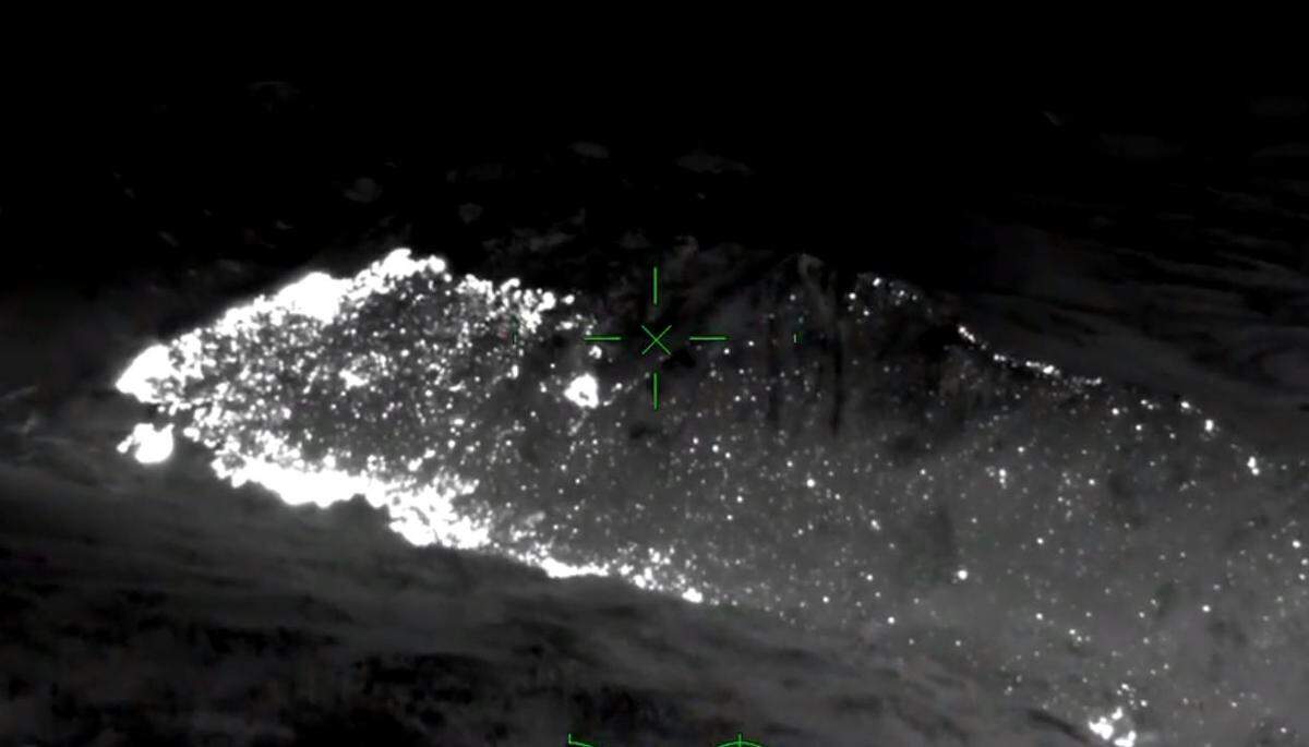 In this infrared aerial image from video looking southeast across the Washburn Fire in Yosemite National Park late Thursday night, July 14, 2022, light areas show the most active fire areas on the east side of the wildfire in the neighboring Sierra National Forest and along the Merced River’s south fork, at lower left. Scattered points of fire are visible to the upper right along the ridgeline of Raymond Mountain.
