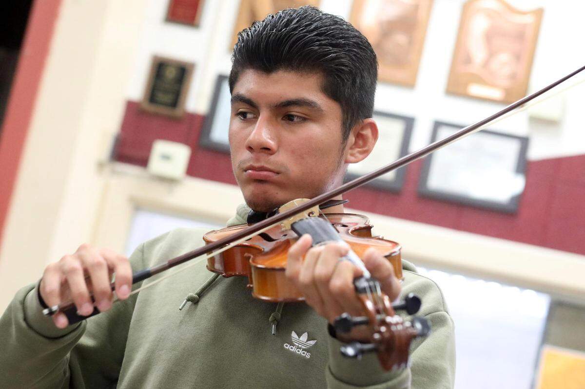 Orosi High School Mariachi Cardenal violin player during the mariachi class on Wednesday, March 15, 2023.