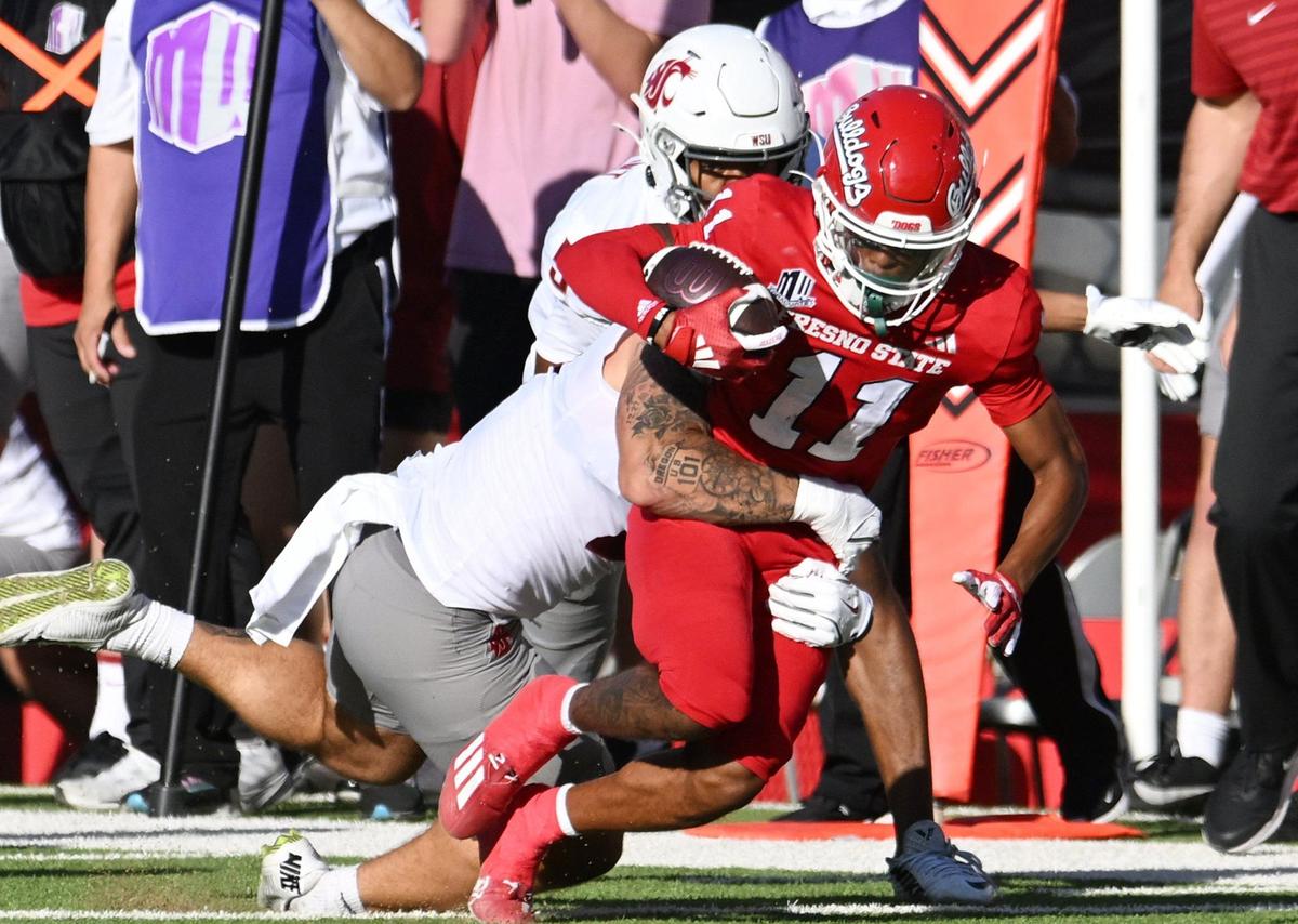Fresno State’s Raylen Sharpe is tackled by Washington State’s Keith Brown, background, Saturday, Oct. 12, 2024 in Fresno.